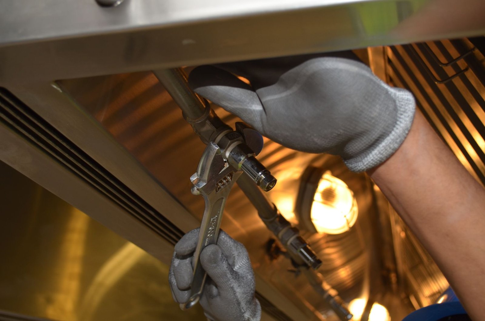 Technician servicing indoor mechanical pipework