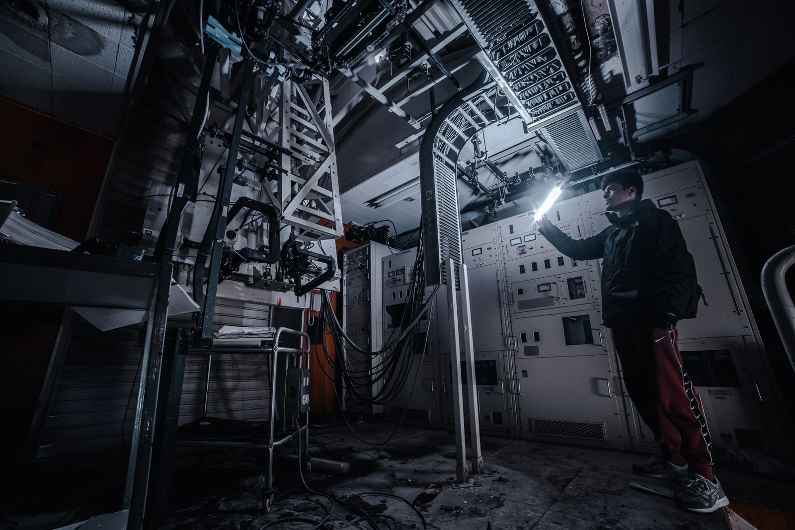 Technician inspecting indoor control equipment