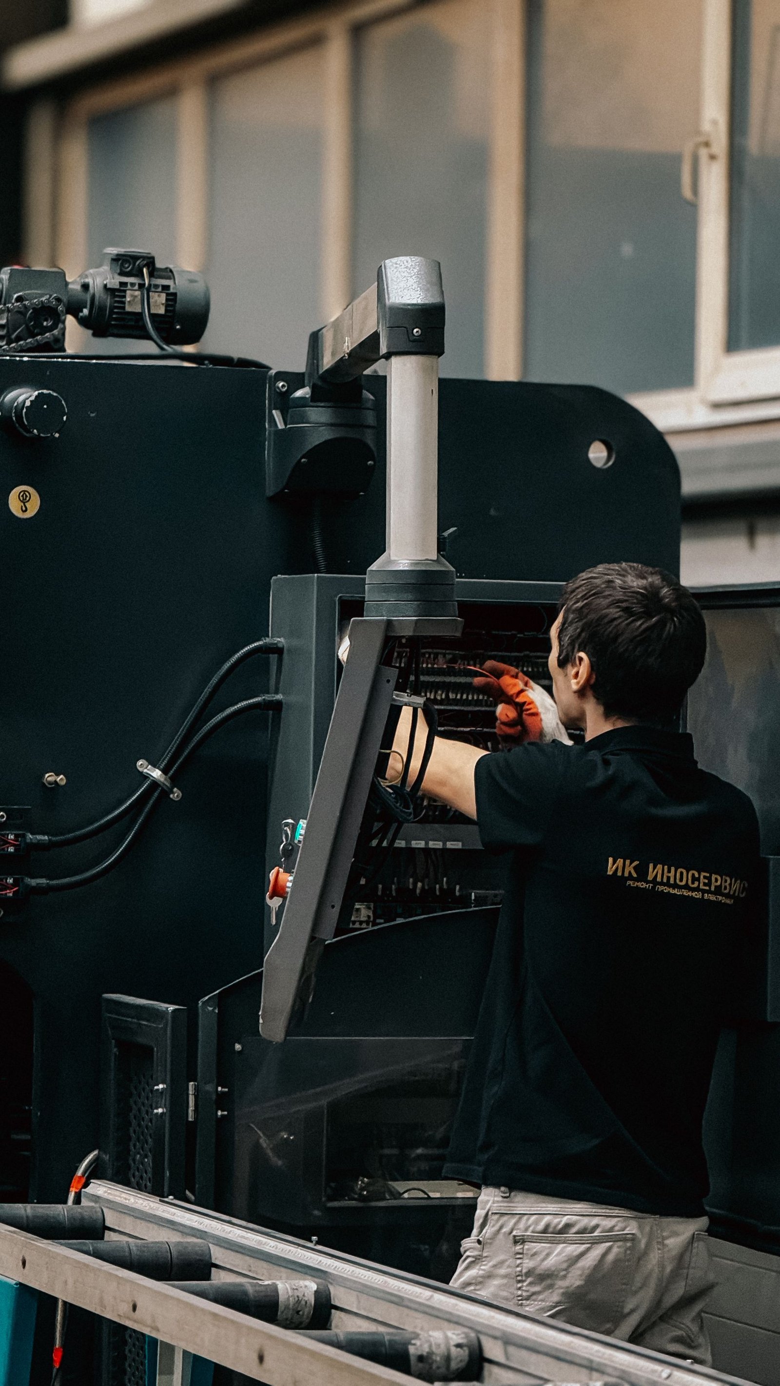 Technician servicing compact mechanical equipment