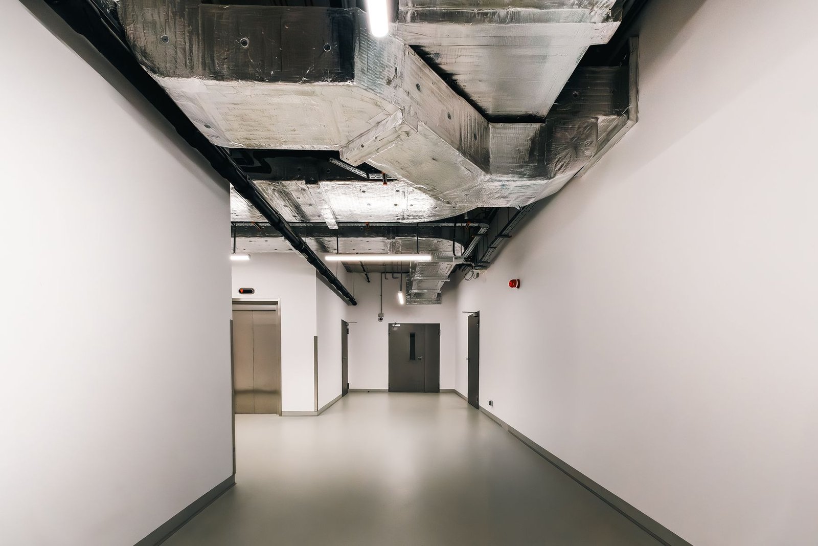 Interior corridor with exposed HVAC ductwork