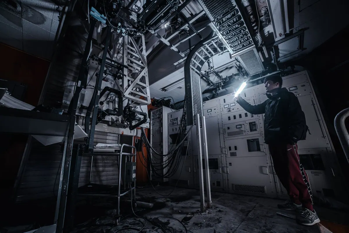 Technician inspecting indoor control equipment